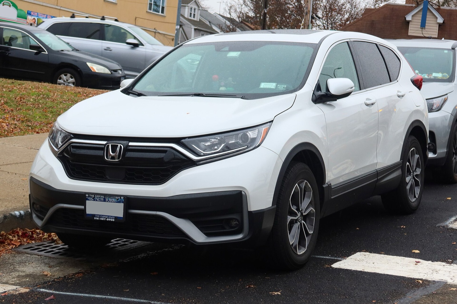 White Honda CR-V parked at a curb