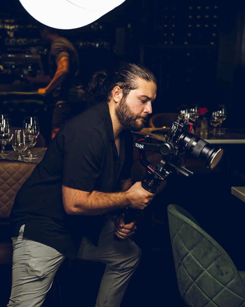 Ryan Chimelis filming with a camera on a gimbal inside a restaurant